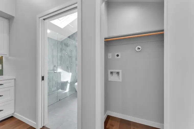 Laundry closet with hookups beside the bathroom door