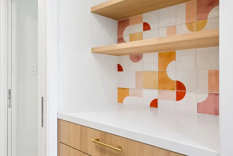 Coffee bar with oak floating shelves and the same patterned tile