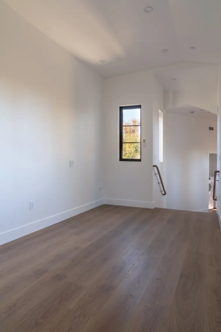 Bright room with a tall window and an arched doorway