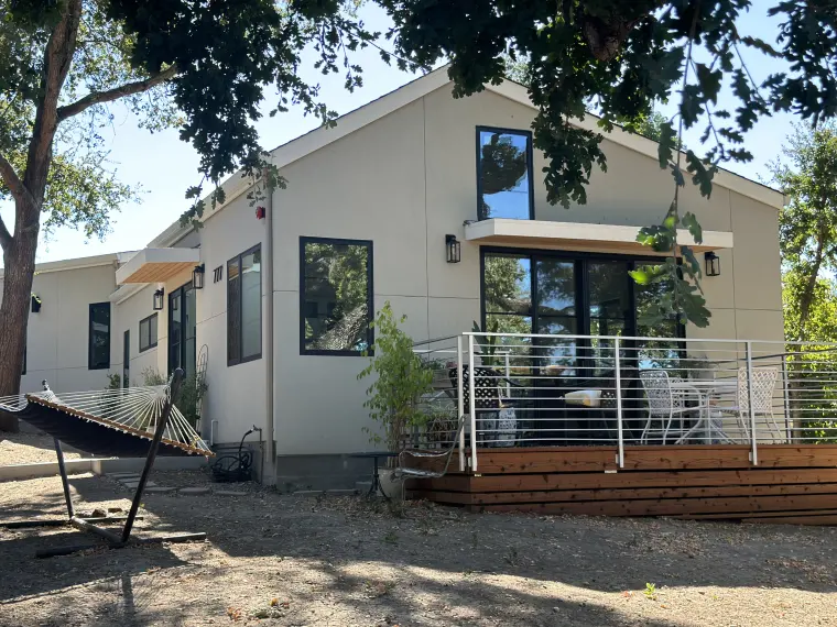 The ADU and its deck from the yard, under the canopy of a large oak