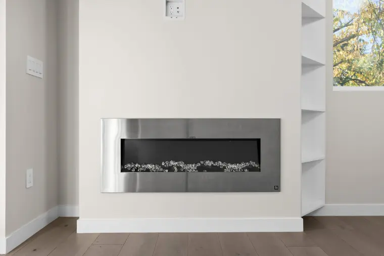 Linear fireplace set flush into the living room wall beside built-in shelves