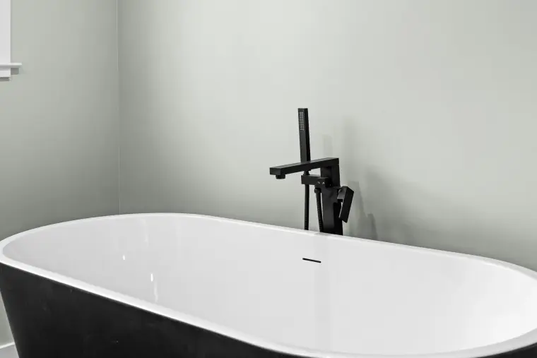 Close view of the freestanding tub and black tub filler