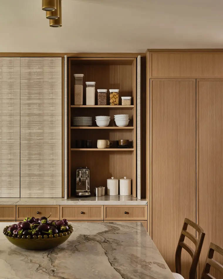 Open white oak pantry shelving between textured-glass cabinet doors