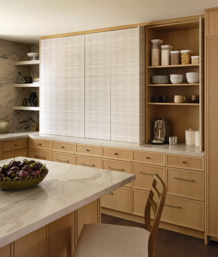 Kitchen corner with textured-glass wall cabinets, open shelves, and a stone counter